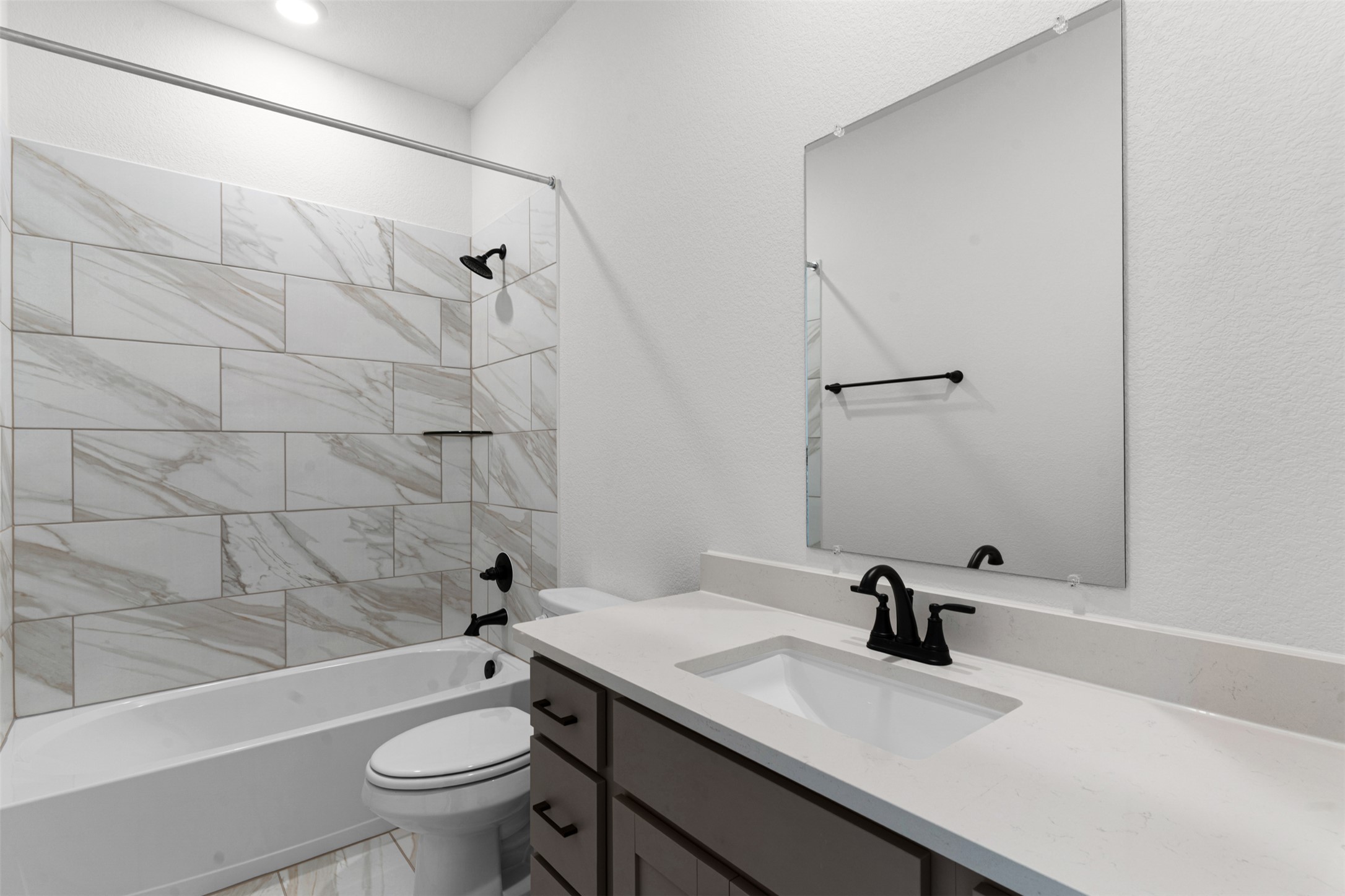 405 Raleigh Drive Georgetown, TX 78633 - Photo 16 of 27 Full bath with vanity, washtub / shower combination, and a textured wall