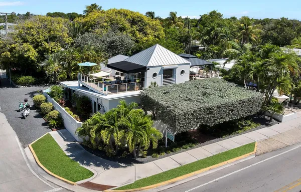 a view of a house with a yard potted plants