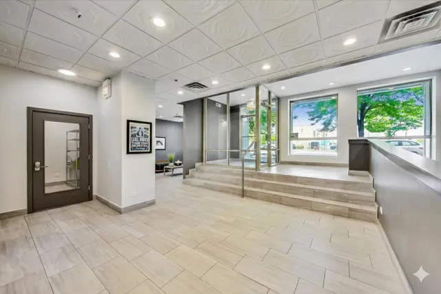 a view of a hall with an entryway and wooden floor