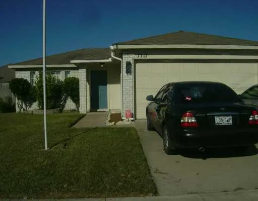 a view of a house with a small yard