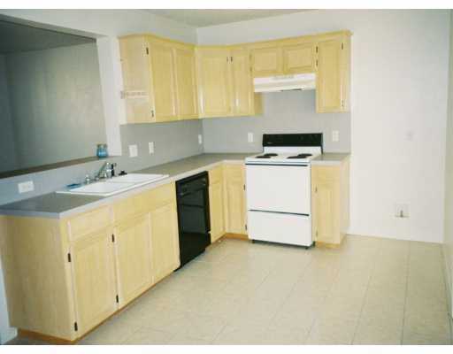 7717 Falcon Drive Corpus Christi, TX 78414 - Photo 3 of 5 a kitchen with a sink a stove cabinets and a window