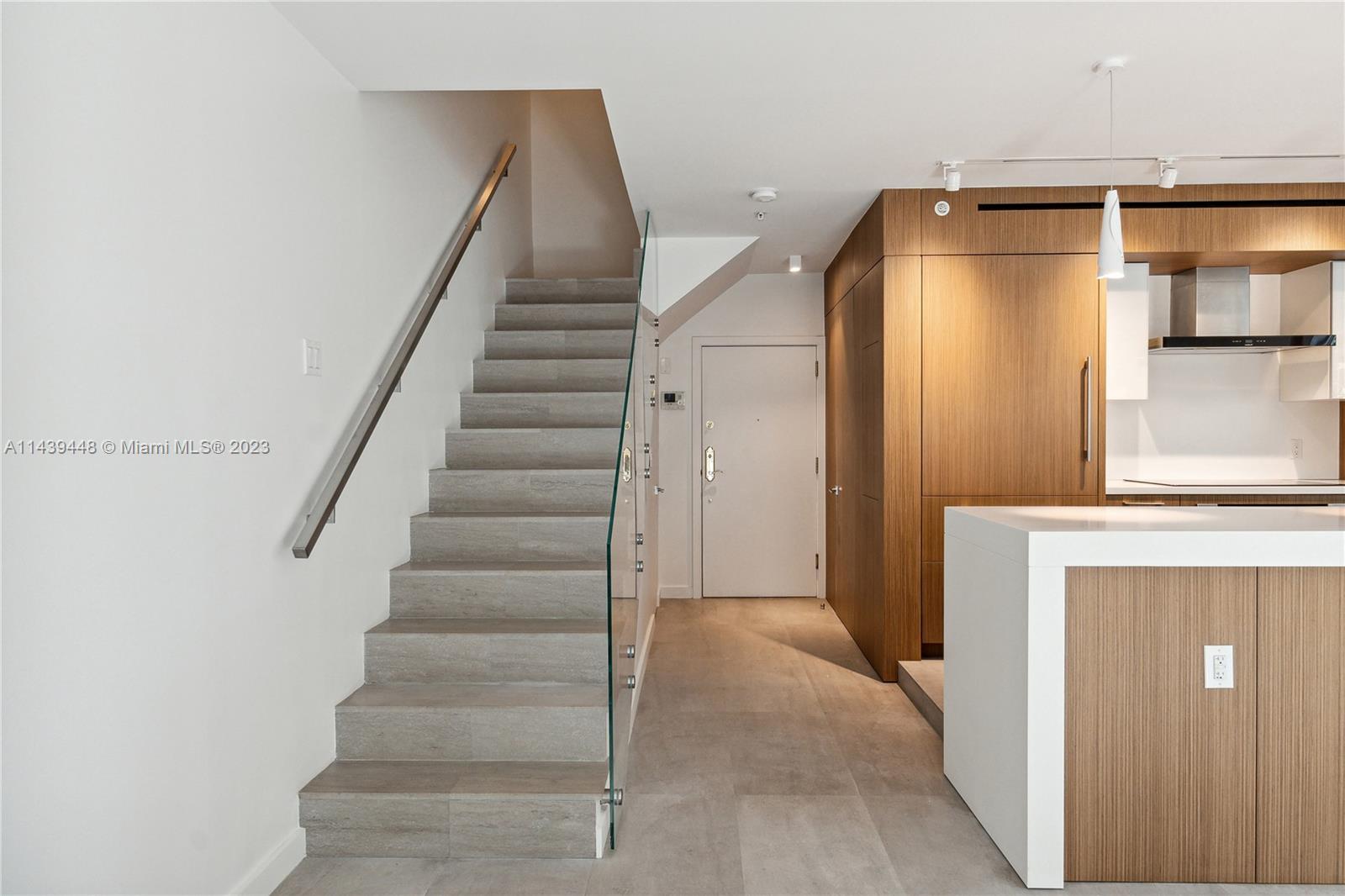 730 3rd Street, Unit 207 Miami Beach, FL 33139 - Photo 7 of 19 a view of a hallway with wooden floor and entryway