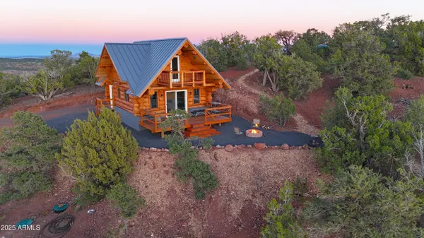 an aerial view of a house with a yard