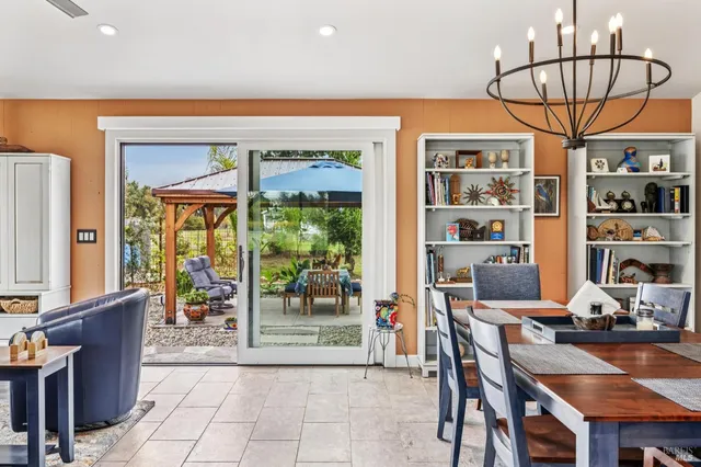 a kitchen with white cabinets and sink
