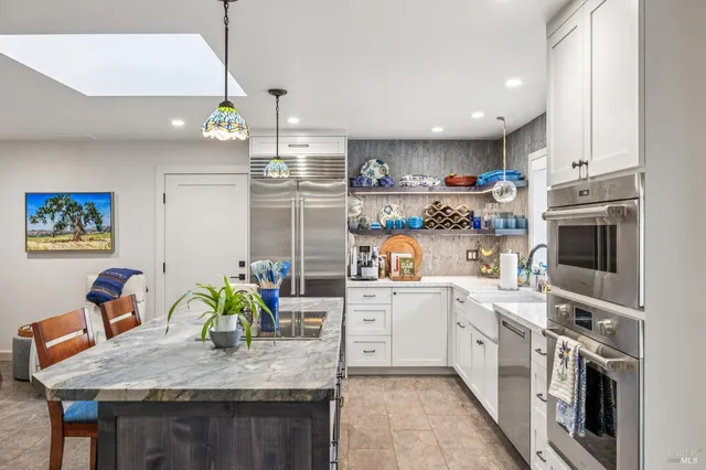 a living room with furniture and kitchen view
