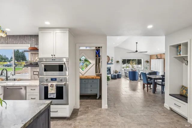 a living room with lots of furniture and view kitchen