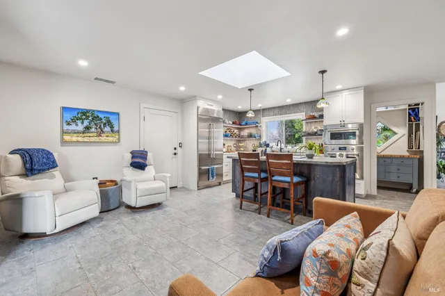 a kitchen with stainless steel appliances granite countertop a sink and a stove