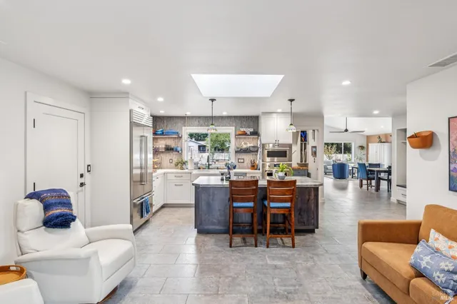 a kitchen with center island table and chairs in it