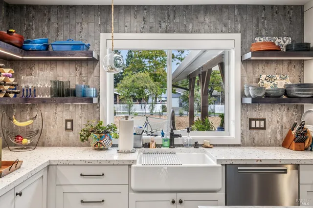 a living room with furniture a flat screen tv and a floor to ceiling window
