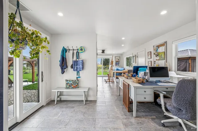 a bedroom with a bed and glass windows