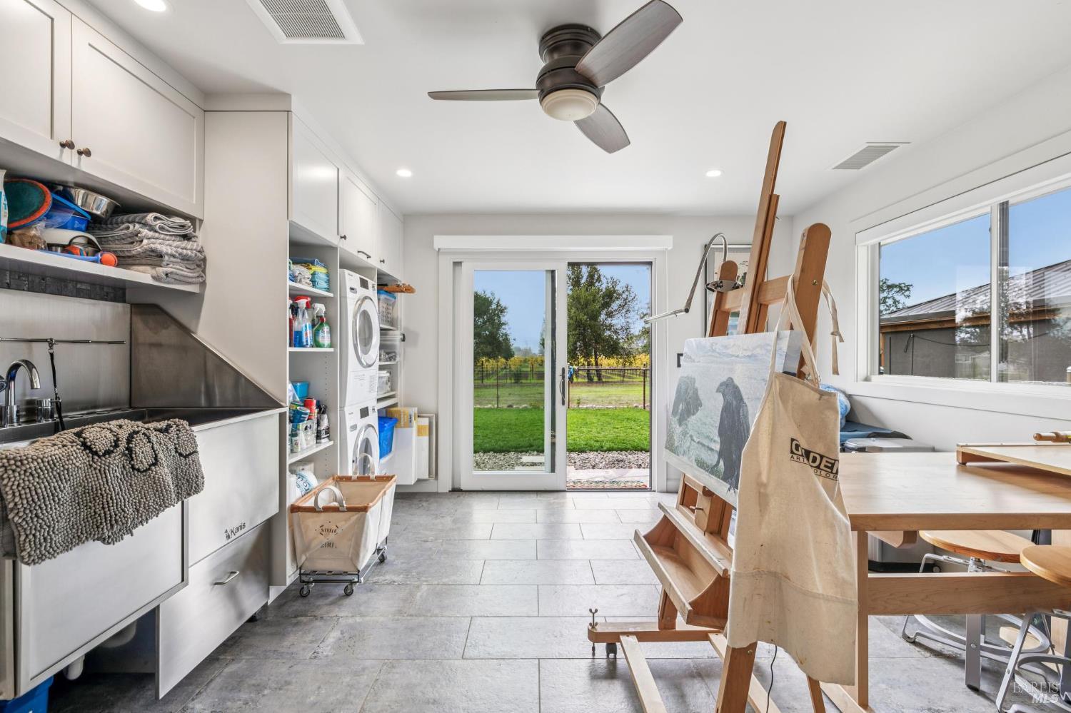 180 Adobe Canyon Road Kenwood, CA 95452 - Photo 32 of 61 a living room with furniture a flat screen tv and a floor to ceiling window