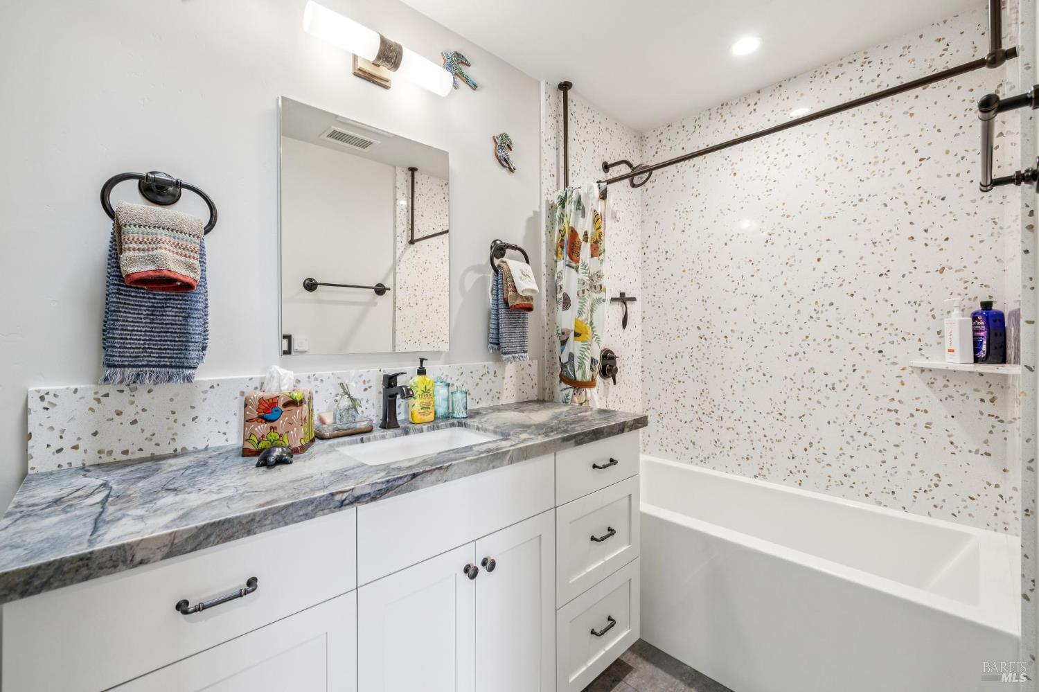 180 Adobe Canyon Road Kenwood, CA 95452 - Photo 41 of 61 a bathroom with a granite countertop sink a mirror a shower and a bathtub