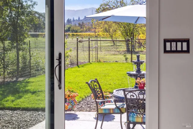 a view of a chairs and table in the patio