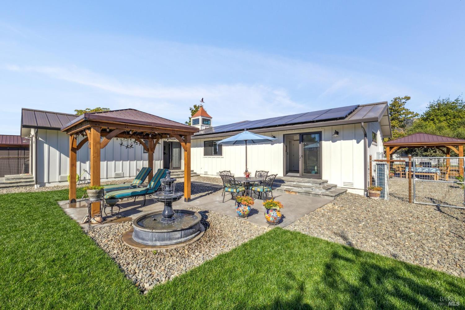 180 Adobe Canyon Road Kenwood, CA 95452 - Photo 45 of 61 a front view of house with a garden and patio