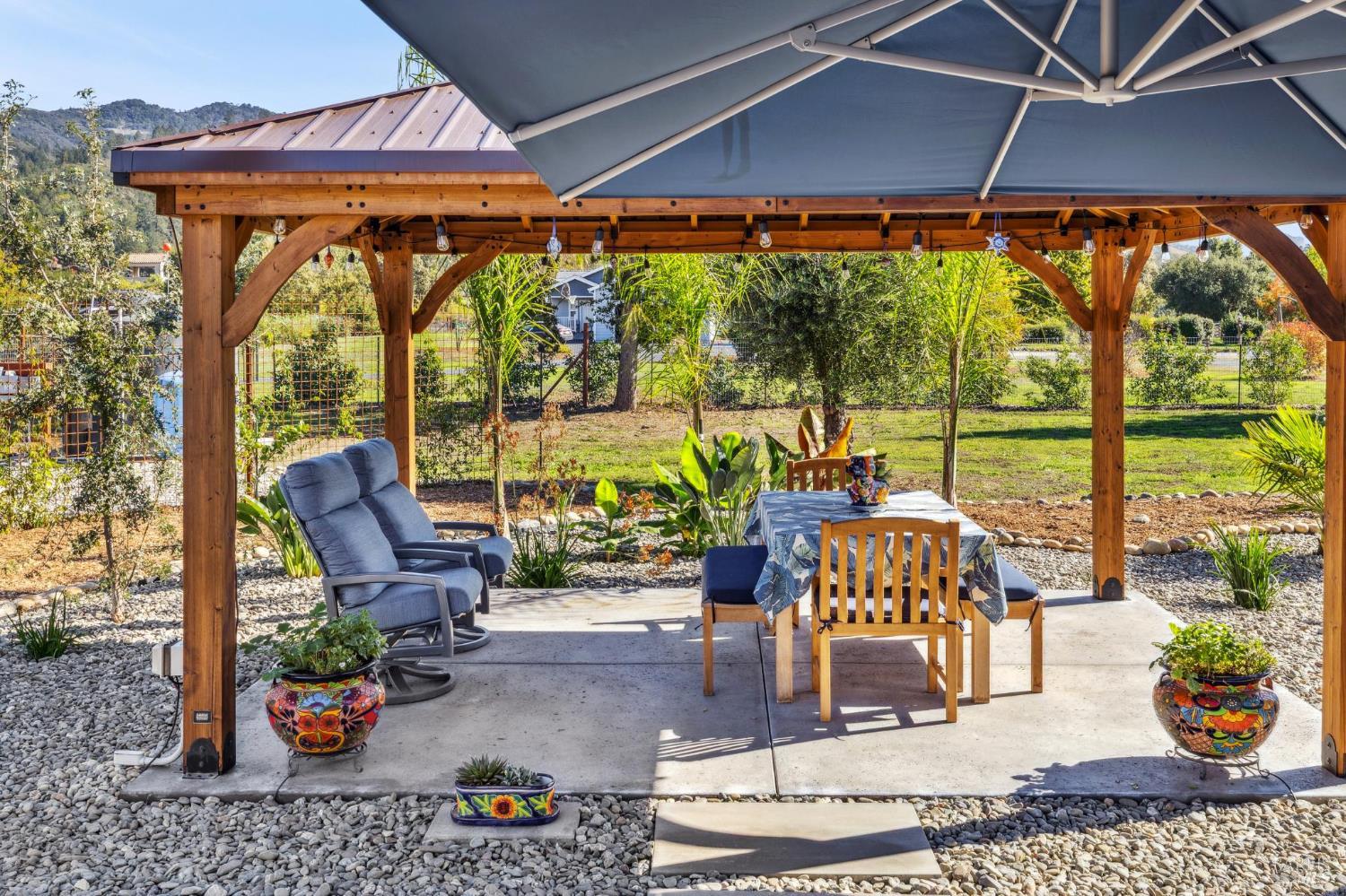 180 Adobe Canyon Road Kenwood, CA 95452 - Photo 47 of 61 a living room with patio furniture and floor to ceiling windows
