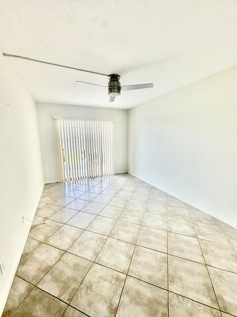 1047 Exeter C Boca Raton, FL 33434 - Photo 10 of 37 a view of a livingroom with white floor and a fan