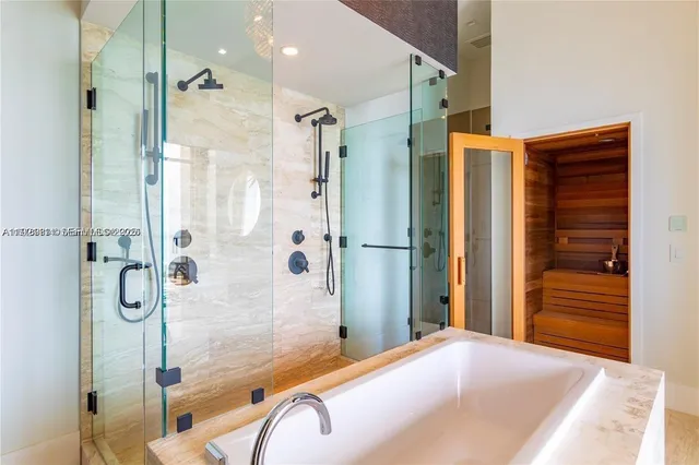 a bathroom with a bathtub and shower