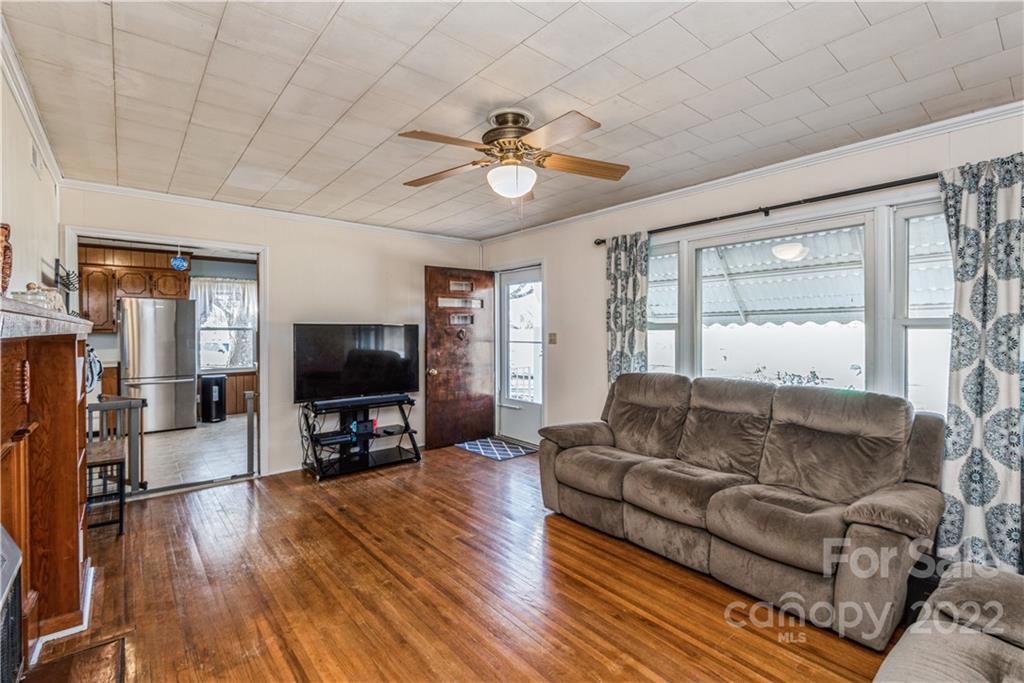 3522 Love Mill Road Monroe, NC 28110 - Photo 5 of 17 a living room with furniture and a flat screen tv with wooden floor