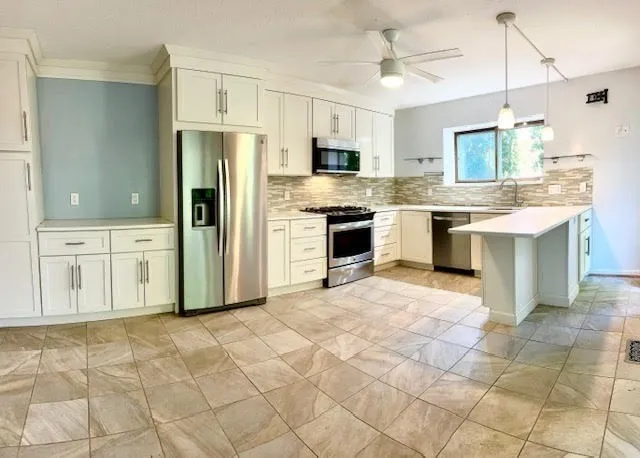 a large kitchen with cabinets and stainless steel appliances