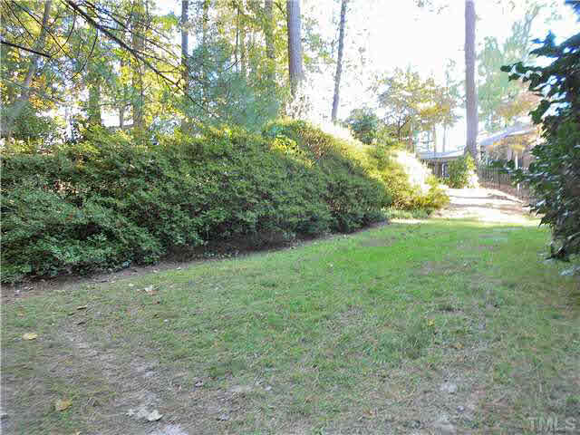 3510 Keats Place Raleigh, NC 27609 - Photo 22 of 25 Mature landscaping includes large boxwoods in front, and this enormous azalea hedge in back.