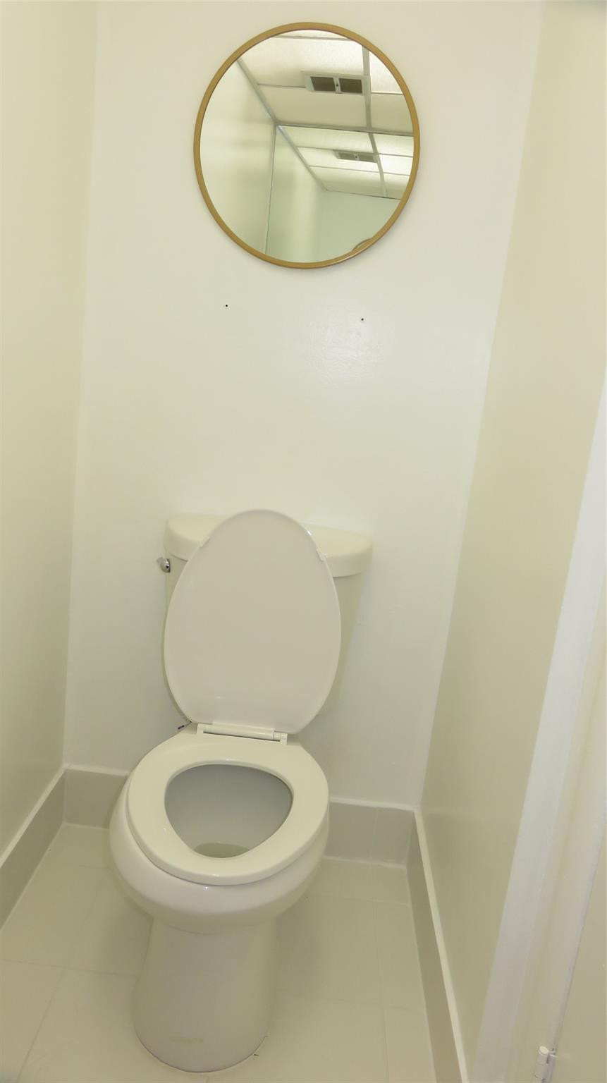 3720 Inverrary Drive, Unit 2C Lauderhill, FL 33319 - Photo 17 of 42 a white toilet sitting next to a white tub