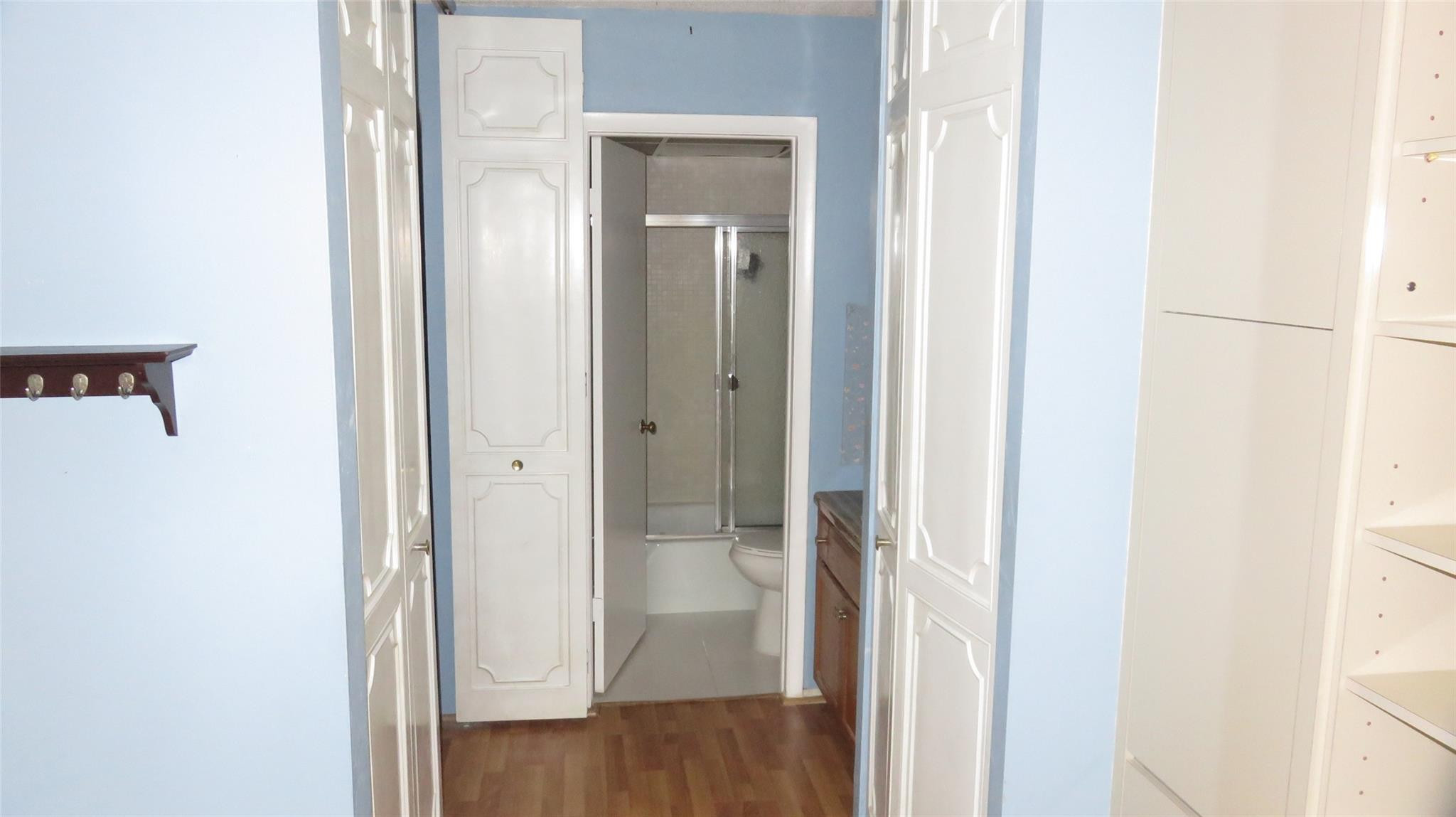 3720 Inverrary Drive, Unit 2C Lauderhill, FL 33319 - Photo 21 of 42 a view of a bathroom from a hallway with wooden floor