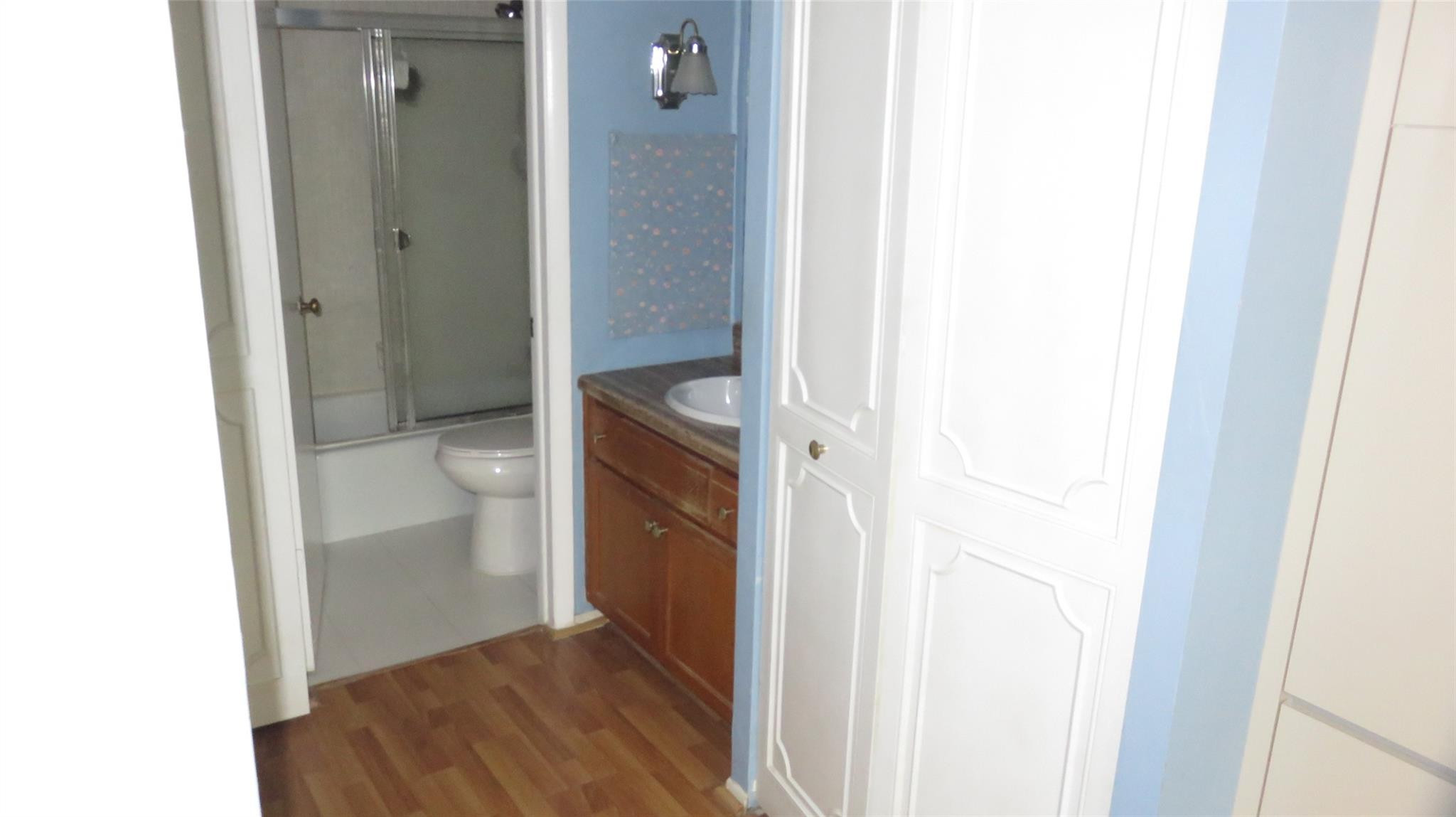 3720 Inverrary Drive, Unit 2C Lauderhill, FL 33319 - Photo 22 of 42 a bathroom with a granite countertop sink