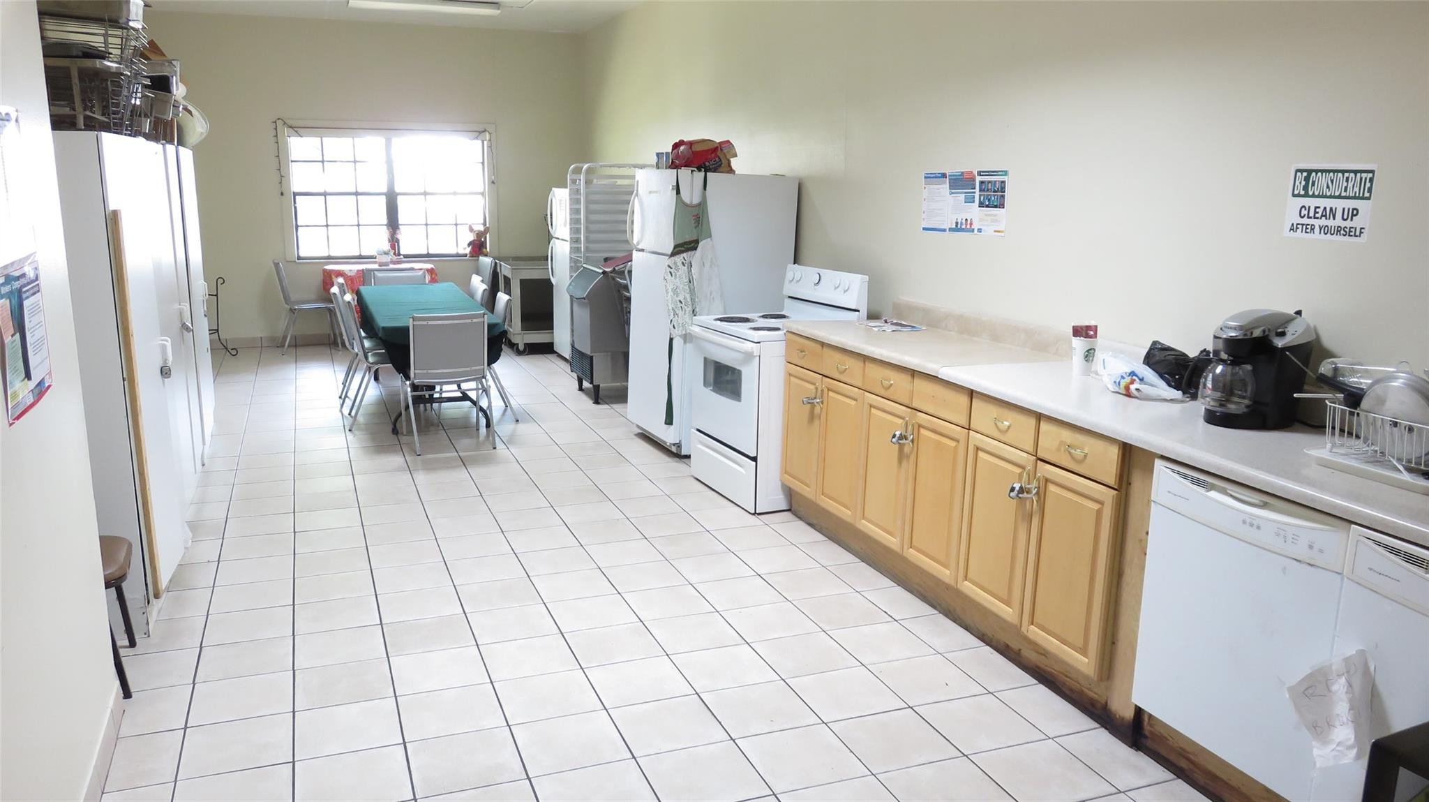3720 Inverrary Drive, Unit 2C Lauderhill, FL 33319 - Photo 40 of 42 a kitchen with stainless steel appliances cabinets a sink and a window