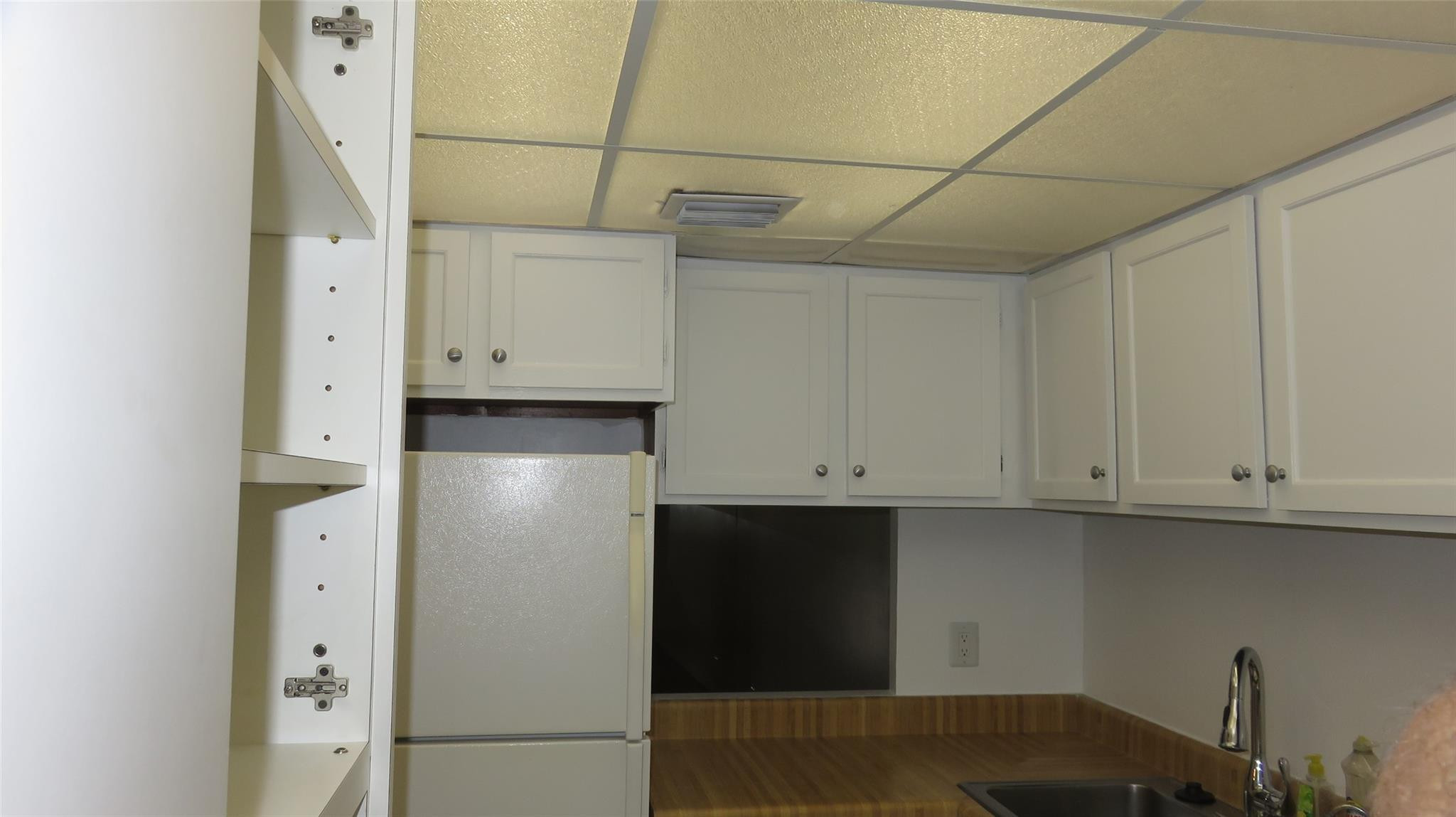 3720 Inverrary Drive, Unit 2C Lauderhill, FL 33319 - Photo 8 of 42 a kitchen with cabinets and a refrigerator