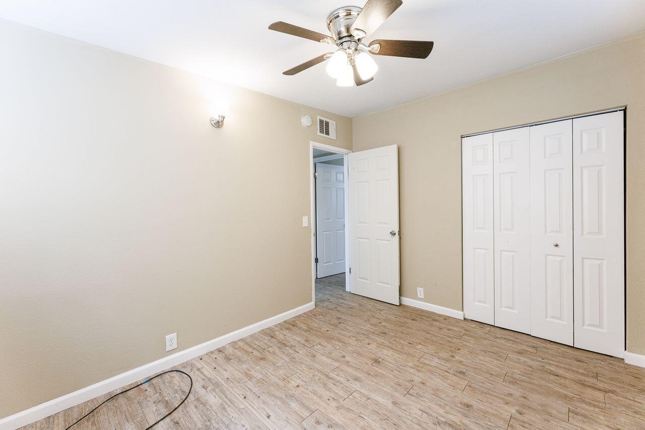 2107 48th Street Lubbock, TX 79412 - Photo 11 of 20 a view of a room with wooden floor and ceiling fan