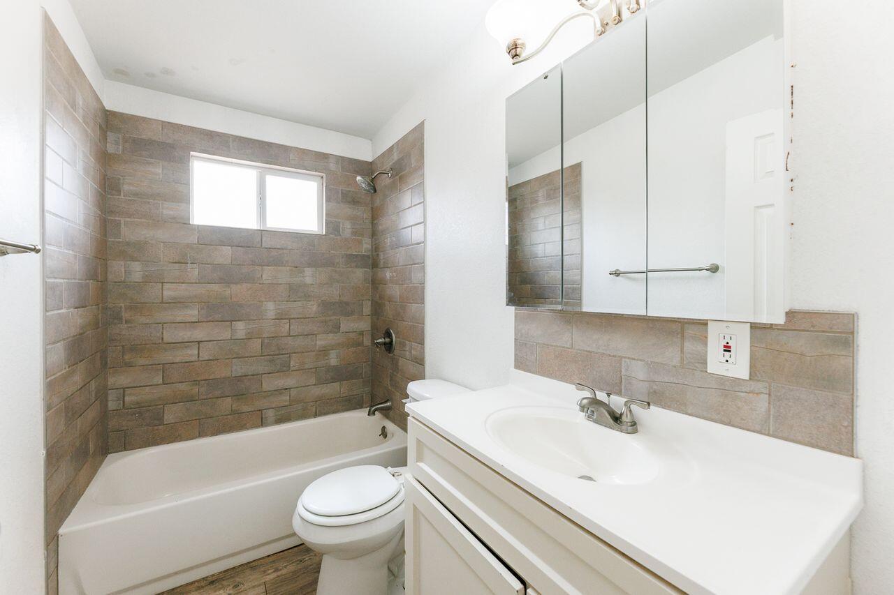 2107 48th Street Lubbock, TX 79412 - Photo 13 of 20 a bathroom with a sink toilet tub and shower