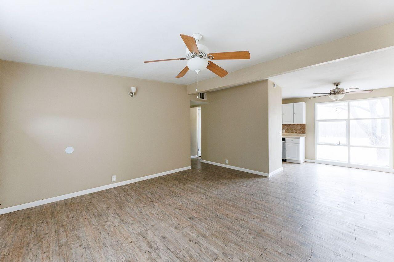 2107 48th Street Lubbock, TX 79412 - Photo 5 of 20 wooden floor in an empty room with a window