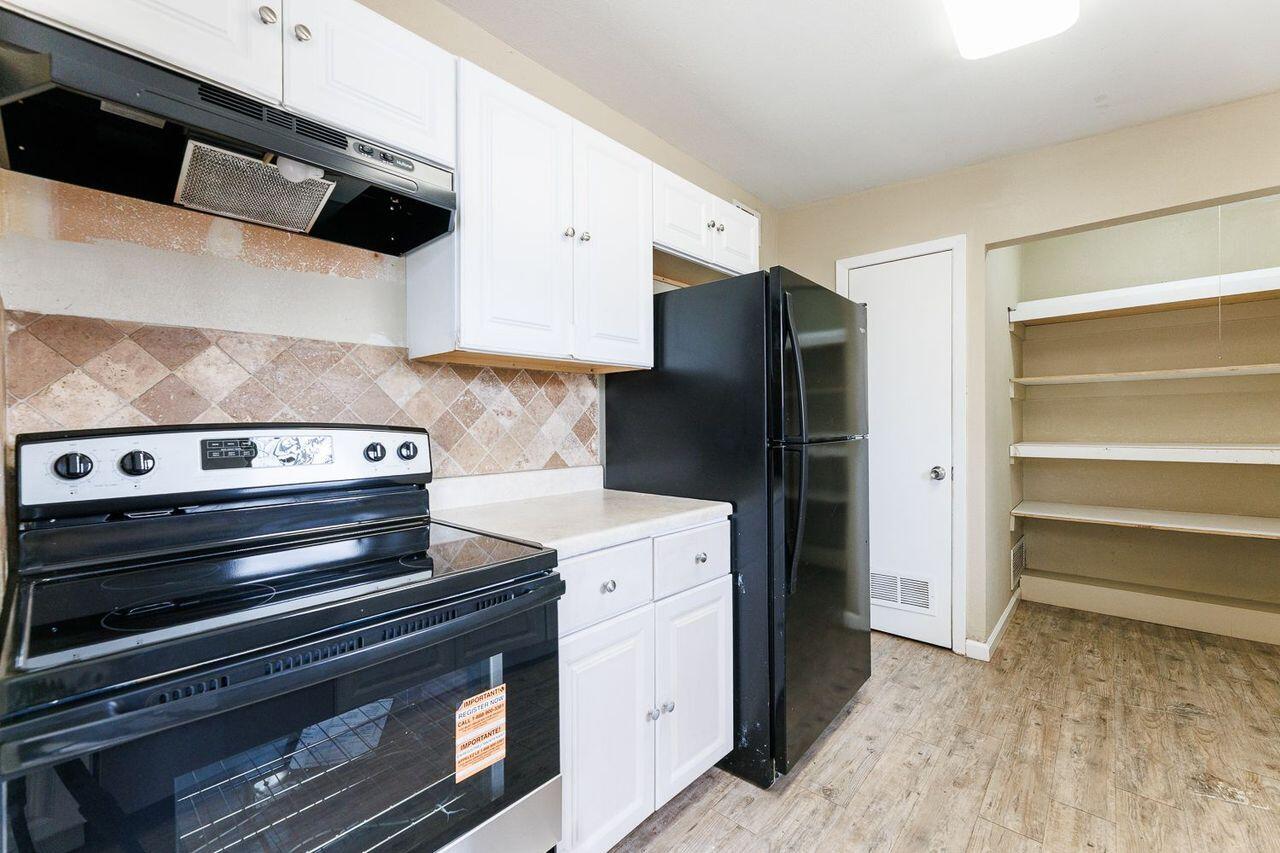 2107 48th Street Lubbock, TX 79412 - Photo 7 of 20 a kitchen with a stove and a refrigerator