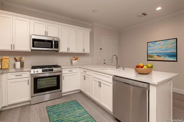 a kitchen with stainless steel appliances granite countertop a sink and a stove top oven