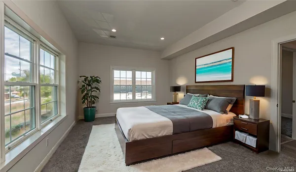 a bedroom with a large bed and a large window
