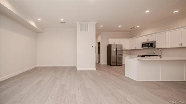 a view of kitchen with stainless steel appliances refrigerator oven and stove