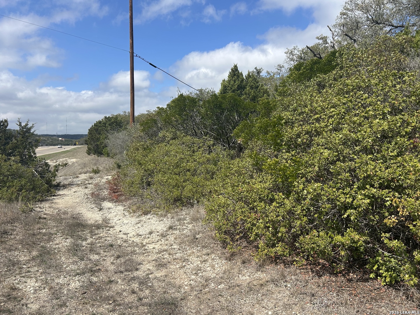 18810 Bandera Road Helotes, TX 78023 - Photo 14 of 29 a view of a pathway of a house with a tree