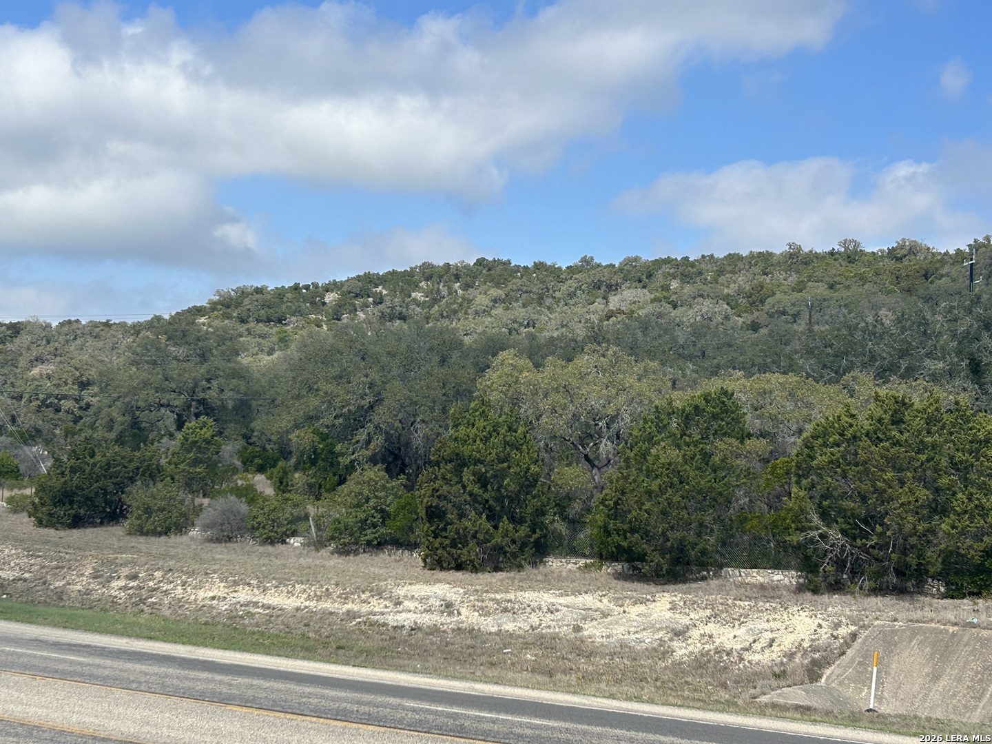 18810 Bandera Road Helotes, TX 78023 - Photo 18 of 29 a view of a yard and mountain view in back