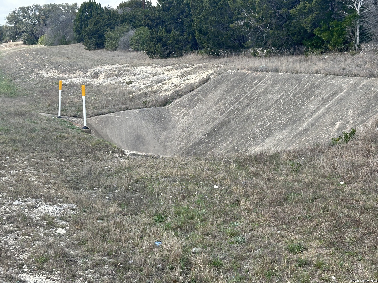 18810 Bandera Road Helotes, TX 78023 - Photo 24 of 29 a view of a dry yard with wooden fence