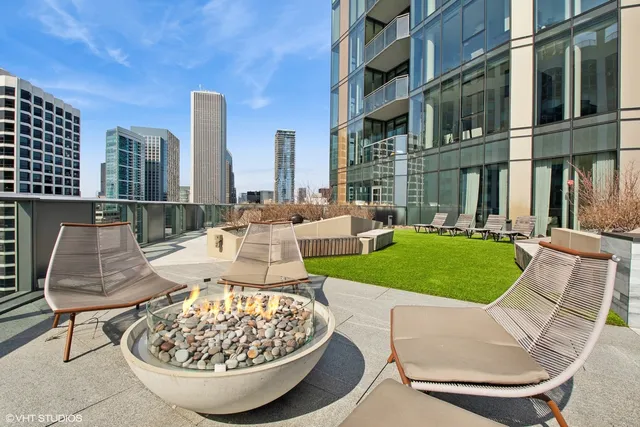 a view of a patio with couches table and chairs and potted plants