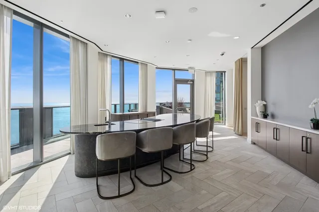 a large dining hall with stainless steel appliances a sink and large window