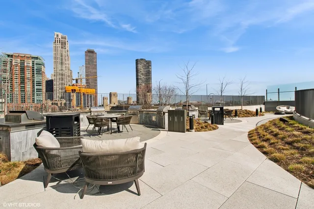 a swimming pool with outdoor seating and city view