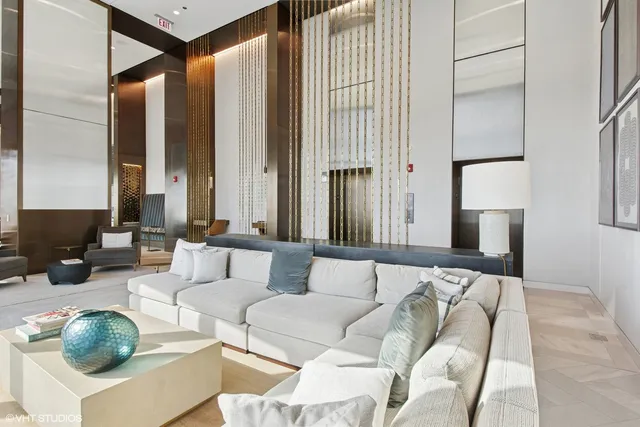 a living room with furniture and large windows