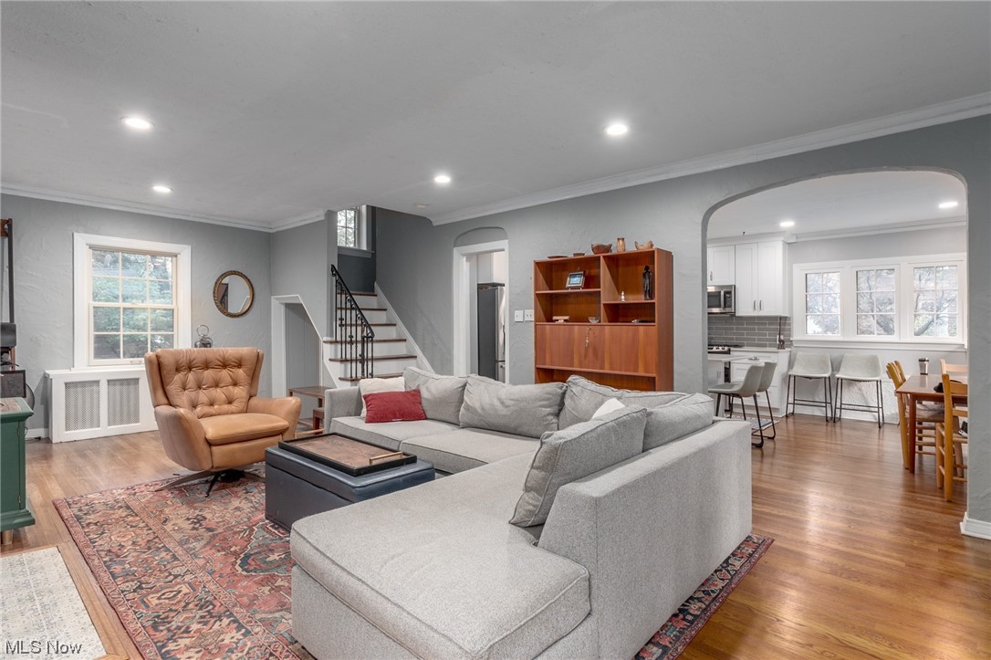 Living room with light hardwood floors and ornamental molding