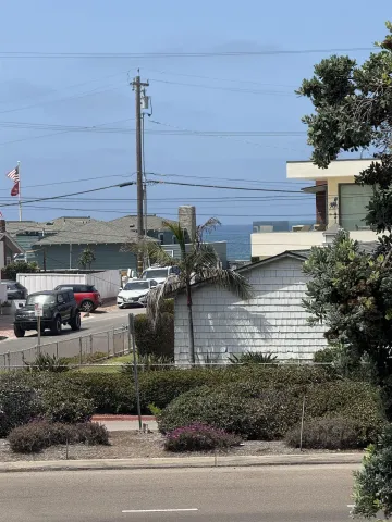 a view of a street with cars parked