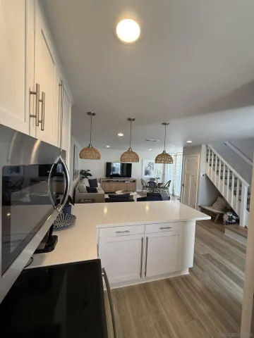 a kitchen with a sink appliances and cabinets