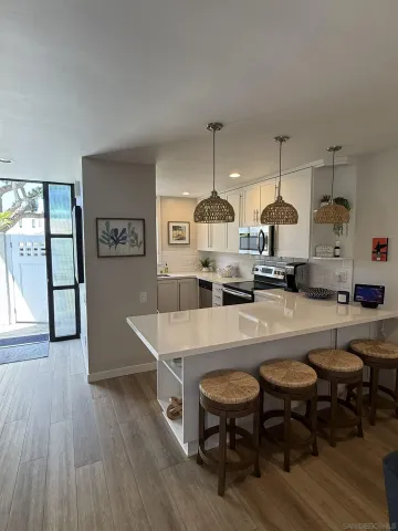 a large kitchen with a table and chairs