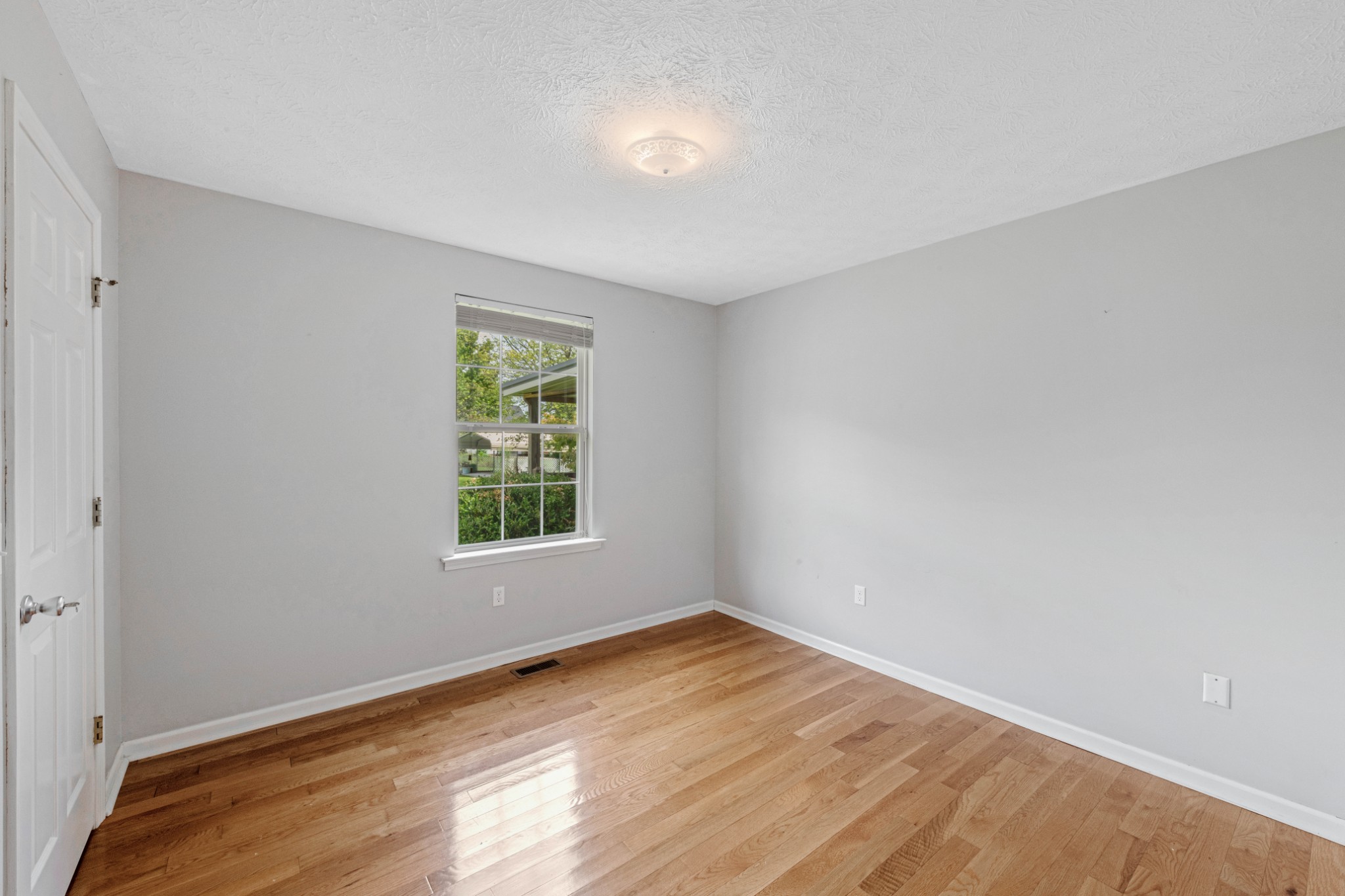 212 Independence Street Springfield, TN 37172 - Photo 16 of 26 wooden floor in an empty room with a window
