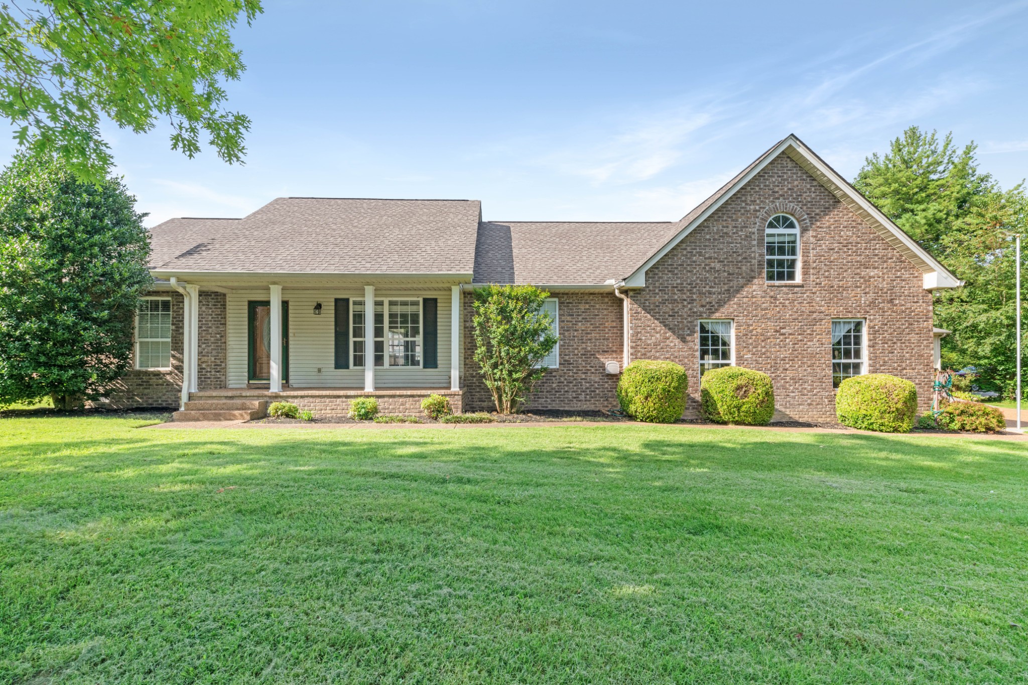 212 Independence Street Springfield, TN 37172 - Photo 2 of 26 a front view of a house with a yard and garage