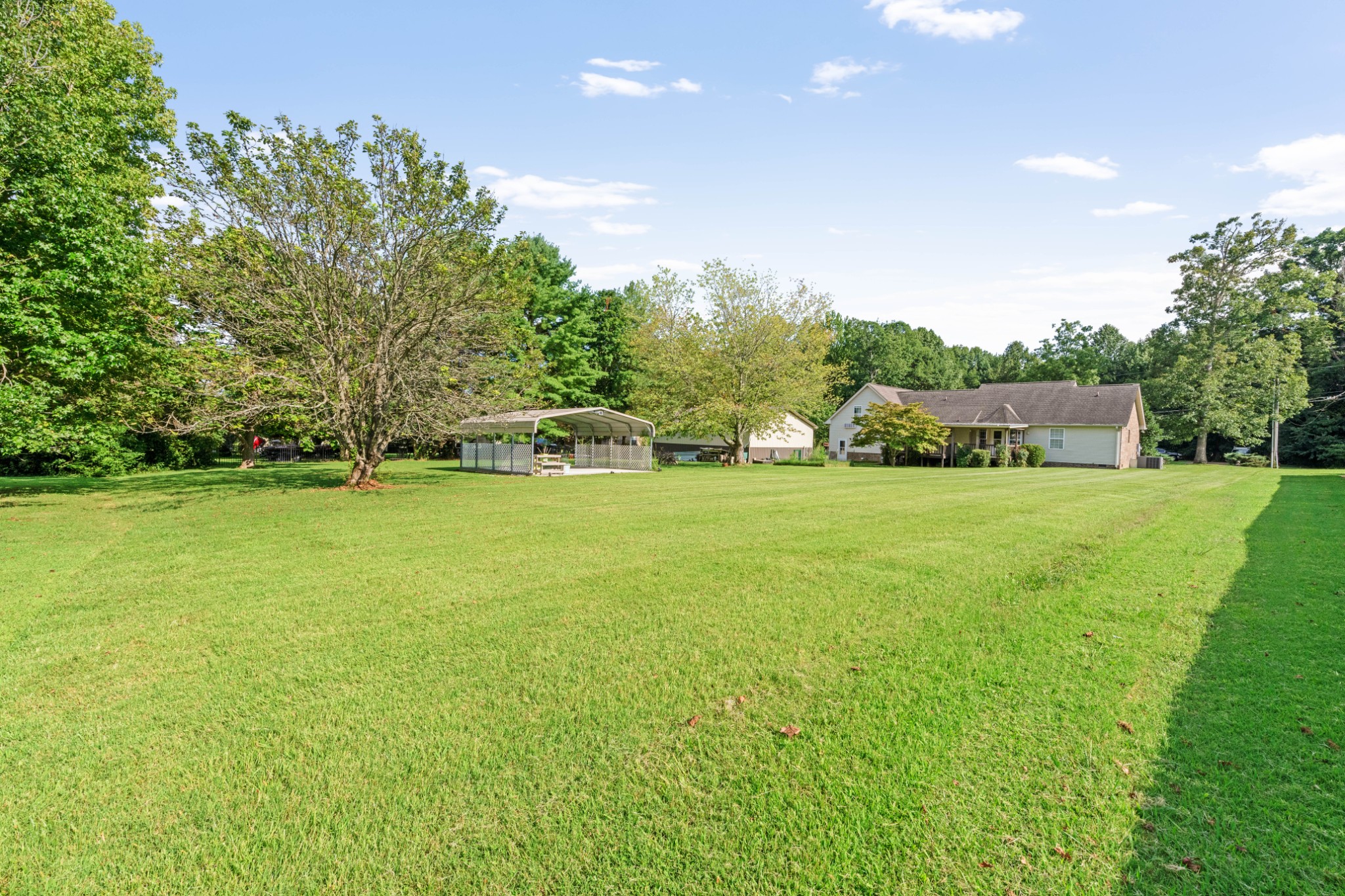 212 Independence Street Springfield, TN 37172 - Photo 26 of 26 a view of a house with a big yard and large trees